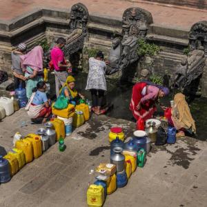 LADIES AT WATER FOUNTAIN IN PATAN NEPAL - 1
